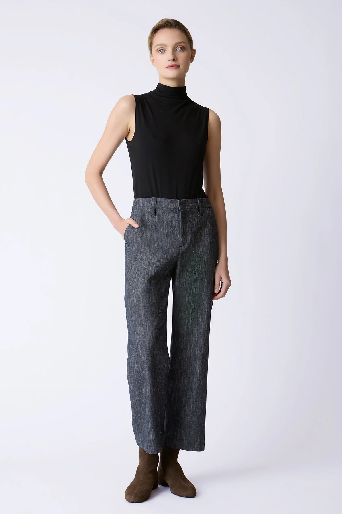 Model wearing the Kal Rieman Joni Pant in indigo, shown from the front with a sleeveless black top and brown ankle boots.