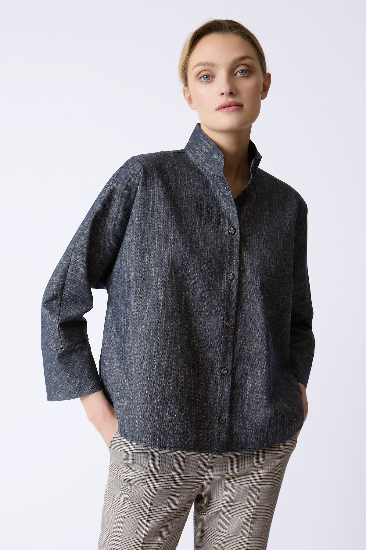 Model wearing the oversized Kal Rieman Maves Shirt in textured indigo denim.