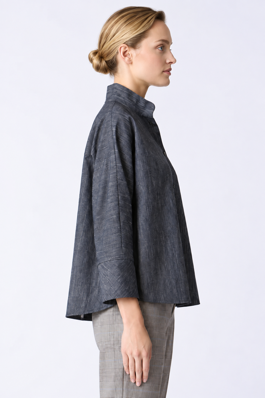 Side view of the Kal Rieman Maves Shirt showing its relaxed kimono sleeves and curved shirttail hem.