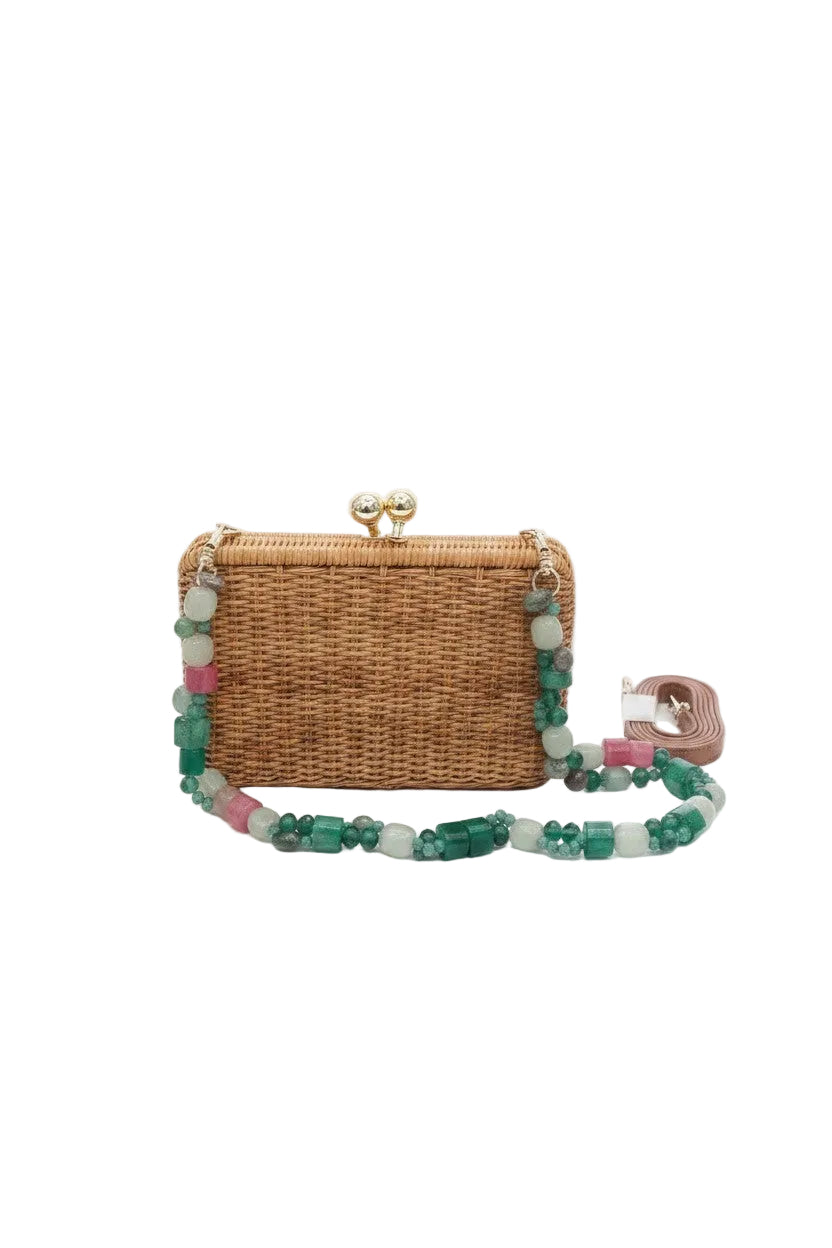 Brown wicker clutch bag with  a detatchable green beaded strap on a white background.