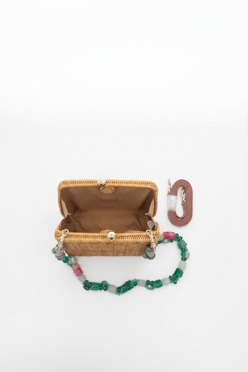 Brown wicker clutch opened on a white background.