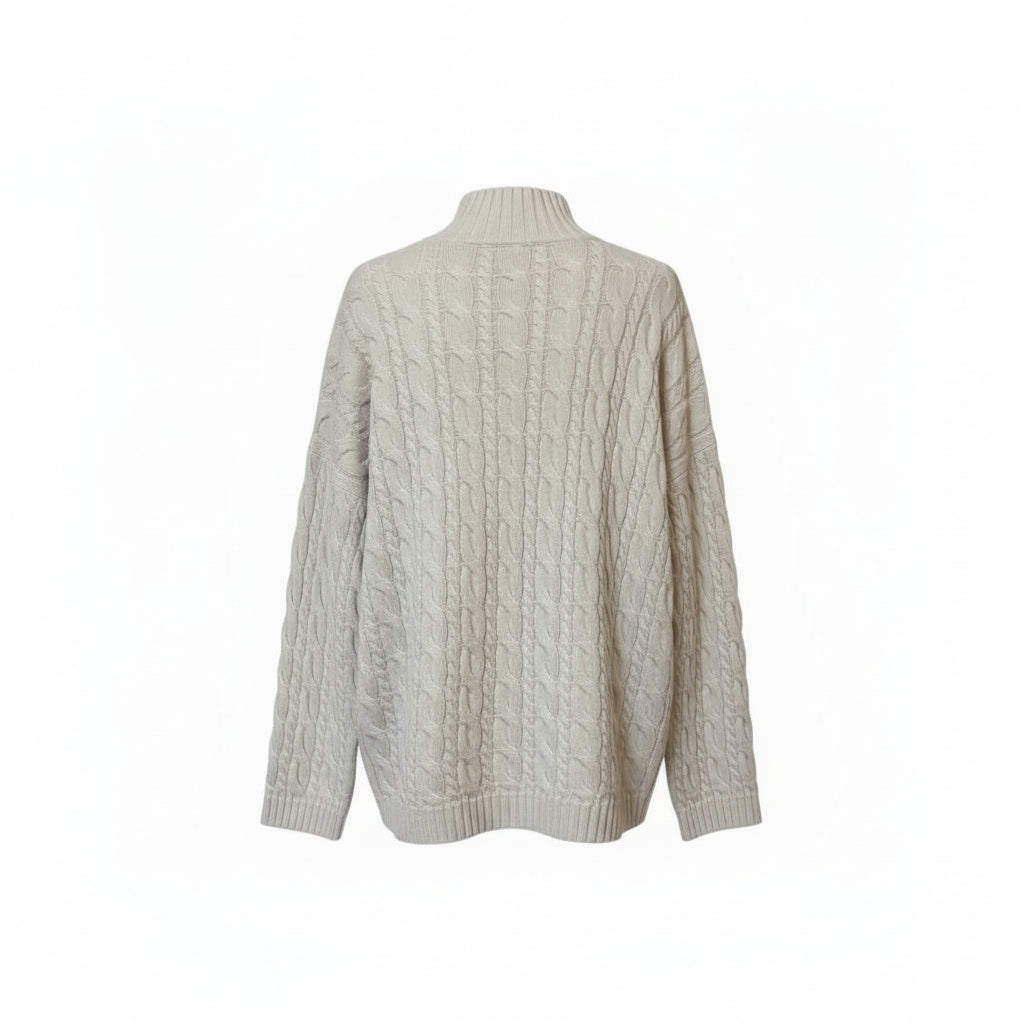 The back of an ivory cable knit sweater on a white background.