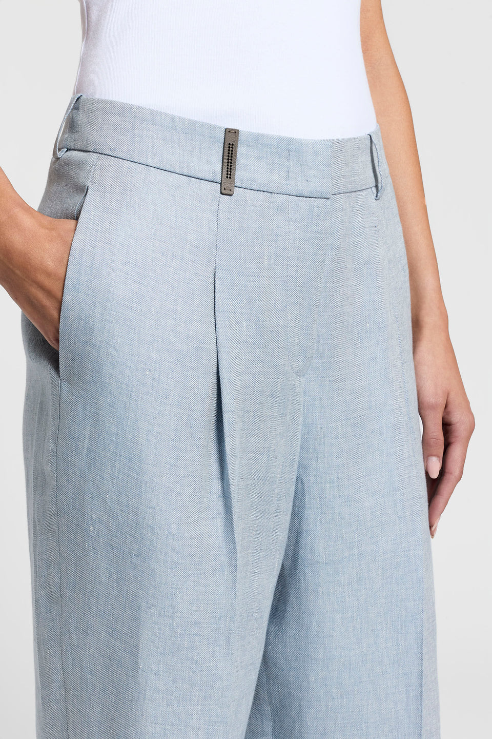 Close-up of blue pants with a white background.
