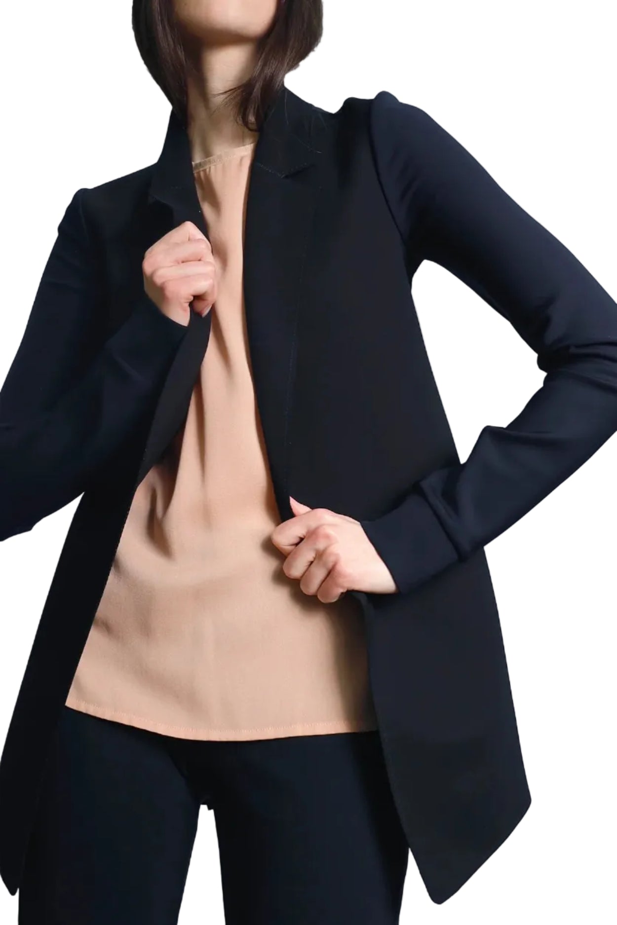 Person wearing a black blazer over a beige top on a white background
