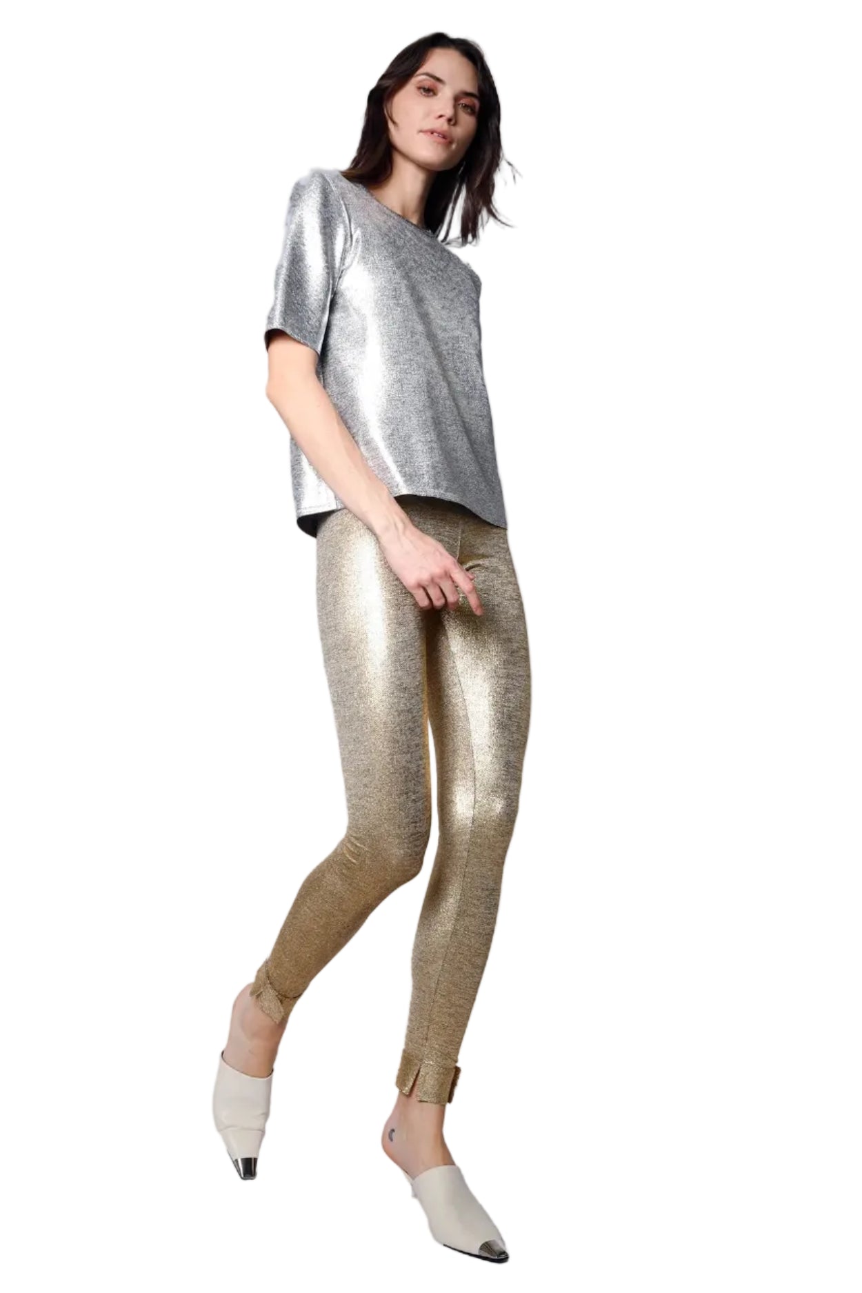 Woman wearing a silver top and gold leggings on a white background