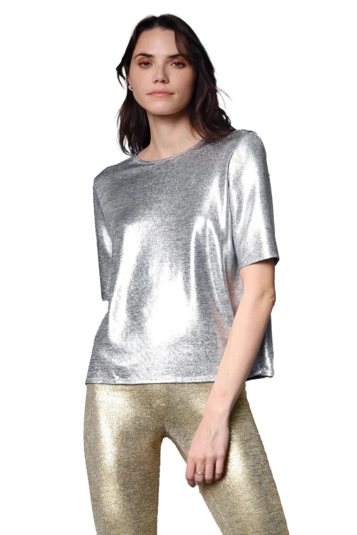 Woman wearing a silver metallic top and gold leggings on a white background.