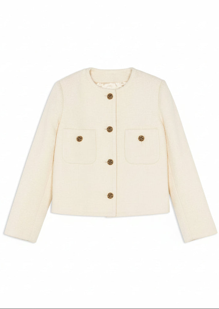 Cream-colored jacket with gold buttons on a white background.