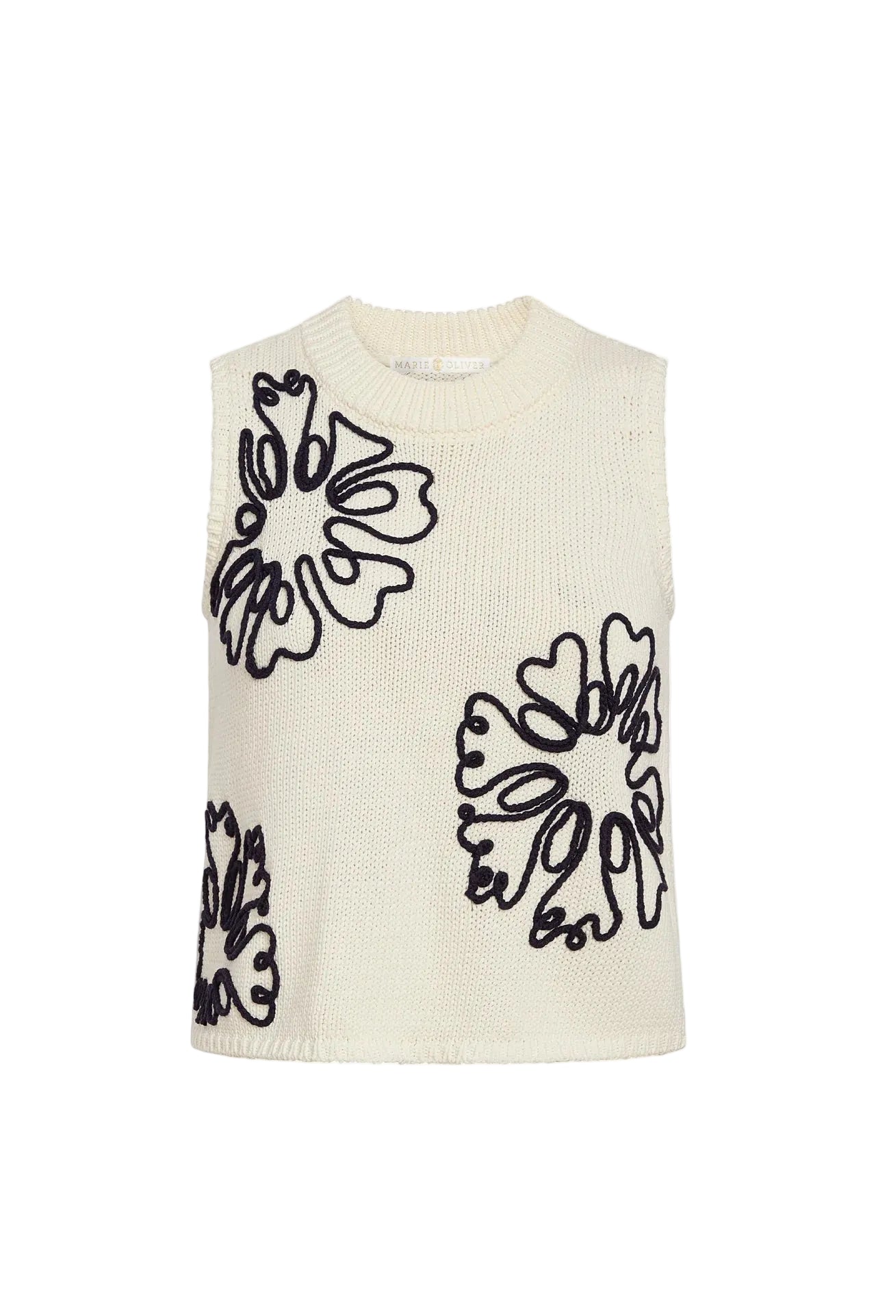White sleeveless sweater with navy abstract leaf patterns on a white background.