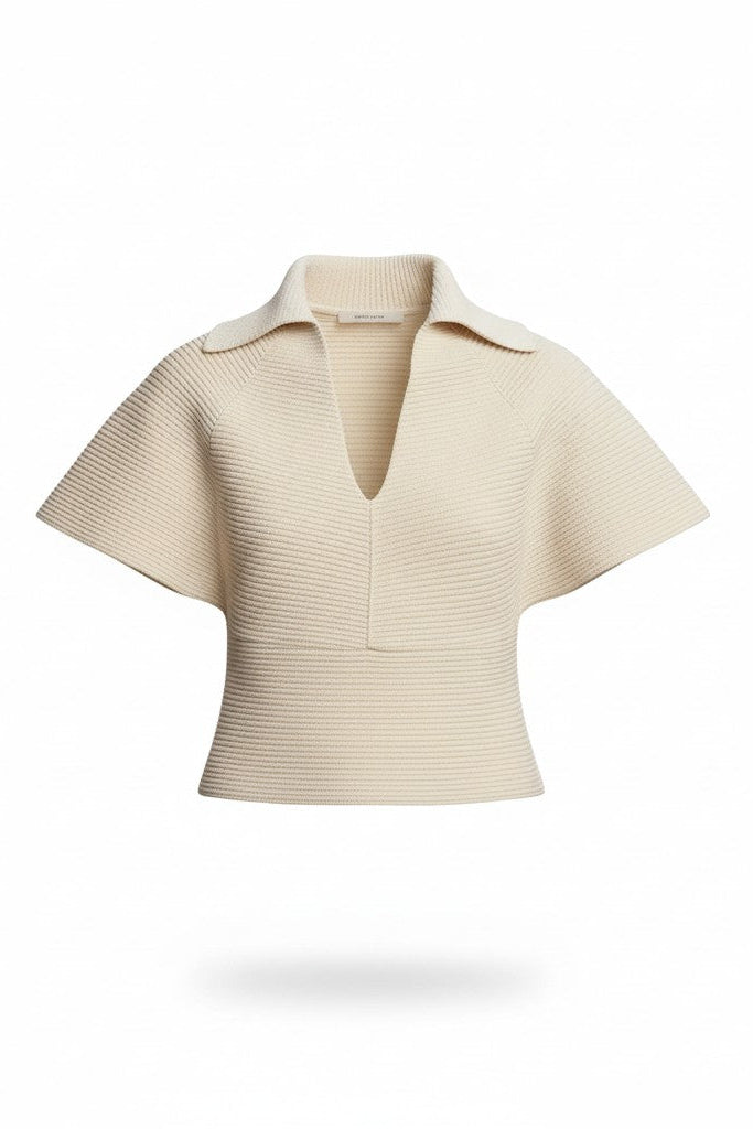 Beige knit top on a white background.