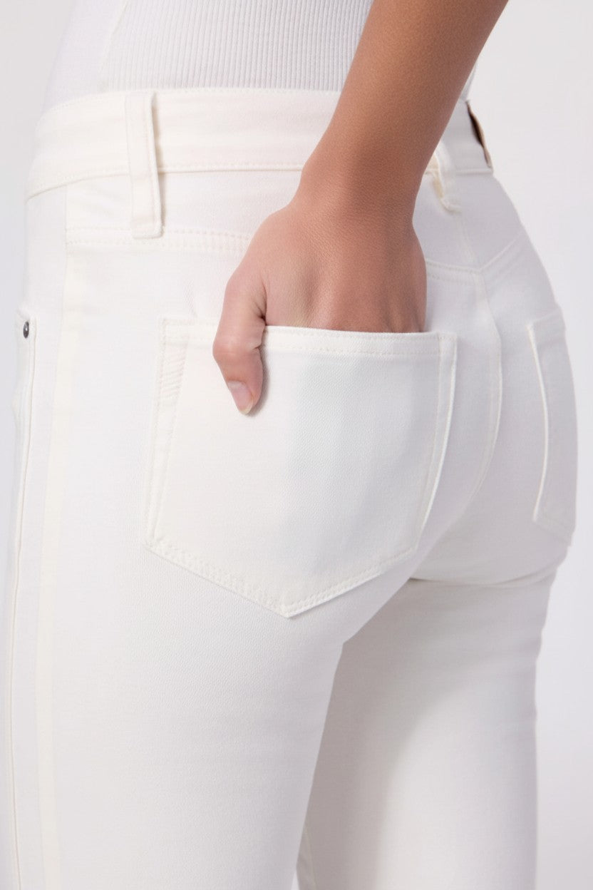White jeans with a pocket, worn by a woman, on a white background.