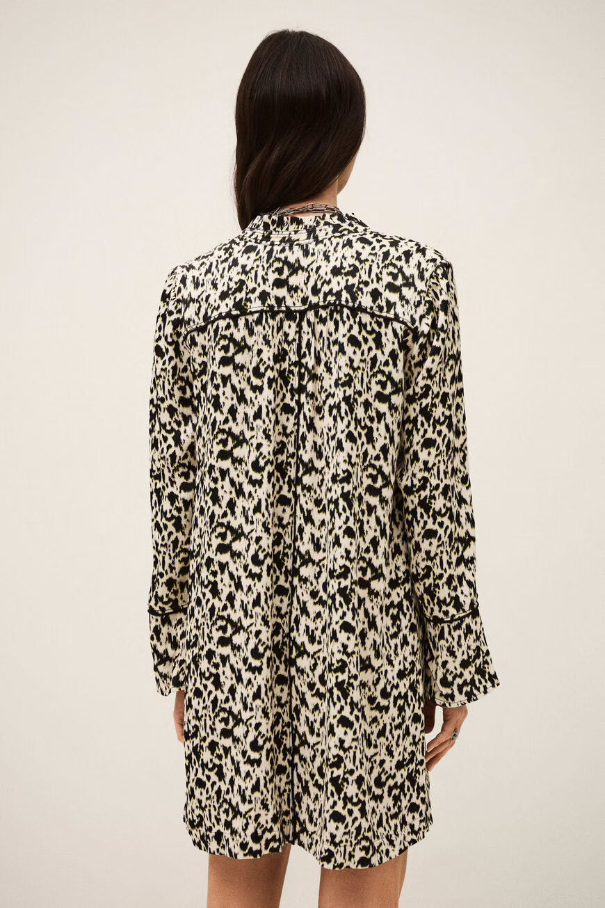 Person wearing a leopard print dress against a plain background.