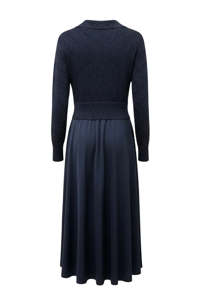 Back of a navy blue dress with long sleeves on a white background.