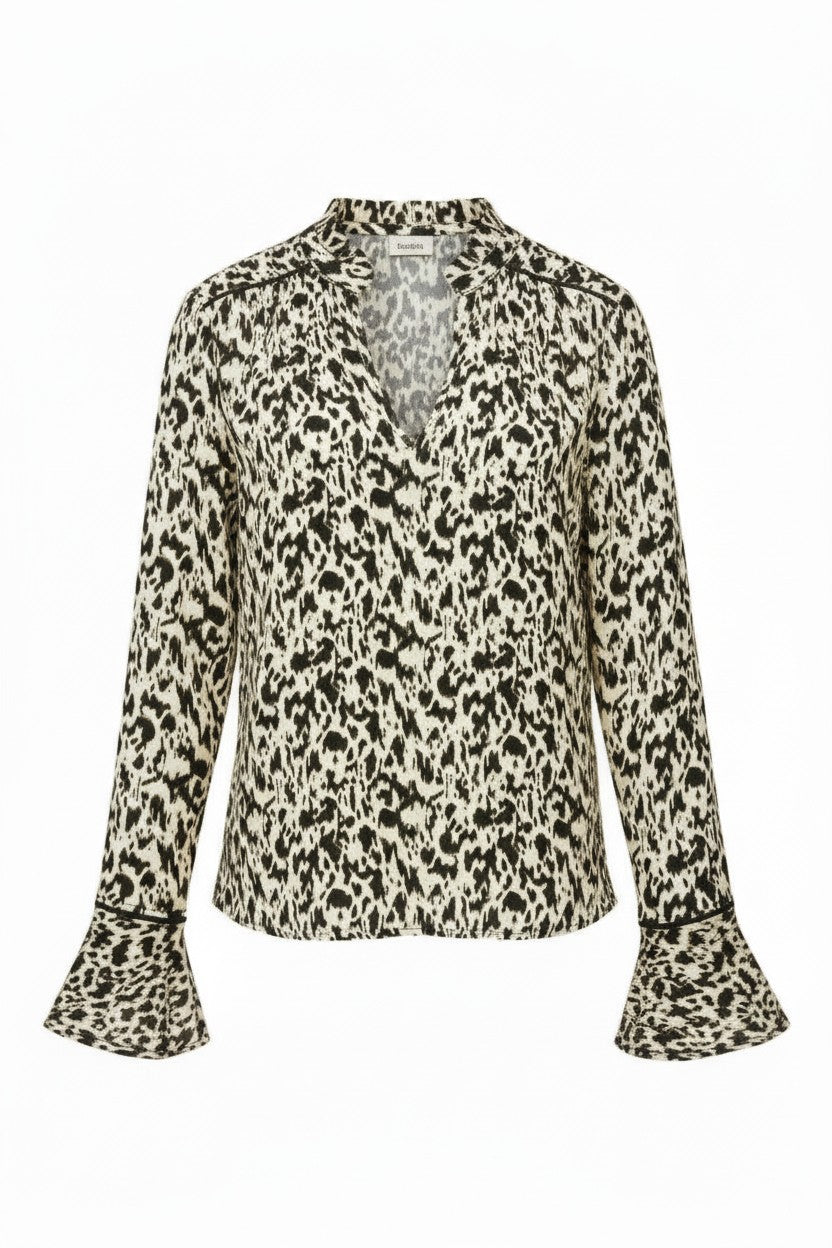 Patterned blouse with long sleeves on a white background.