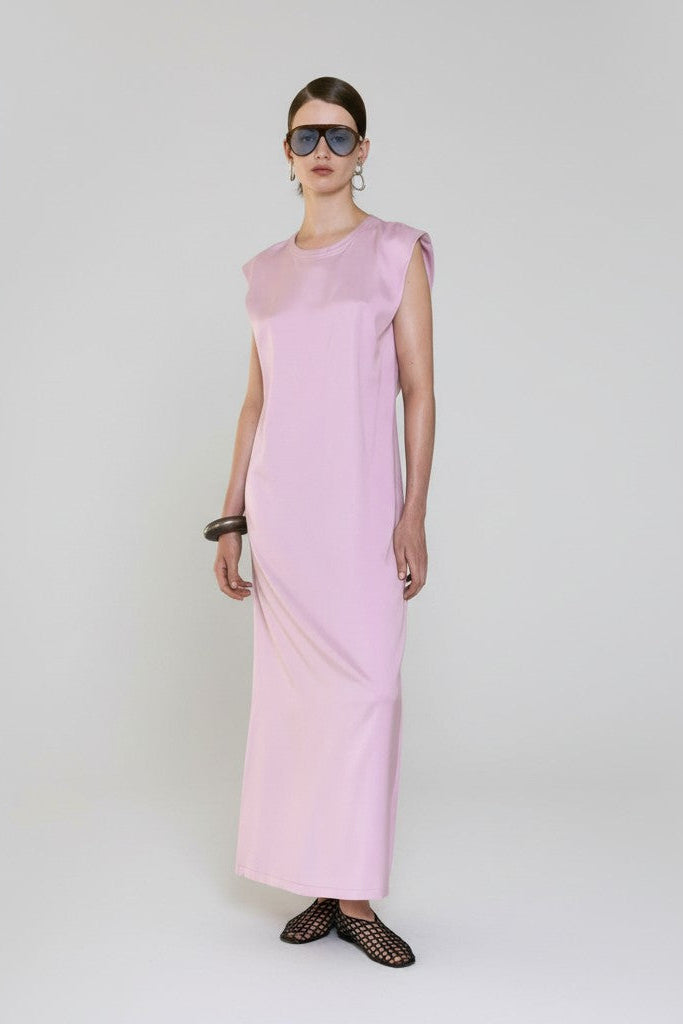 Woman wearing a pink dress on a white background.