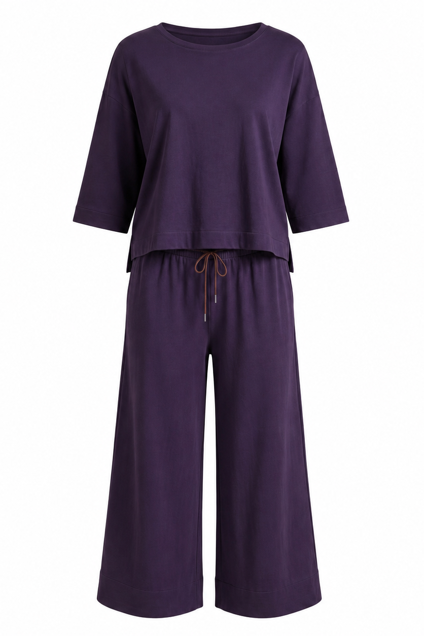 QL2 Costanza two-piece set in deep plum, featuring a relaxed elbow-sleeve top and wide-leg cropped drawstring pants on a white background.
