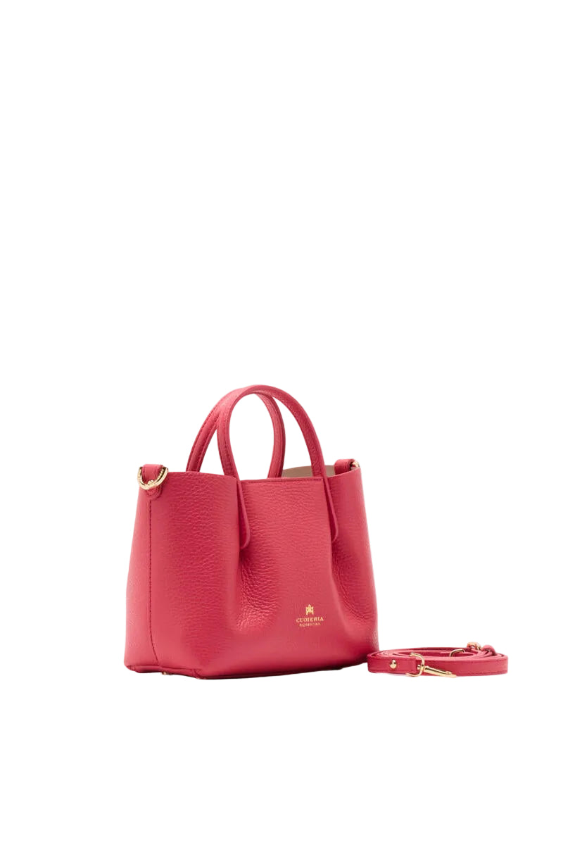 Red handbag with a strap on a white background.