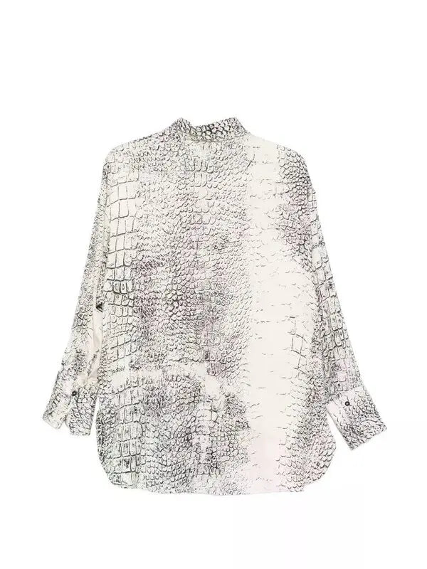 The back of a white blouse with black pattern on a white background.