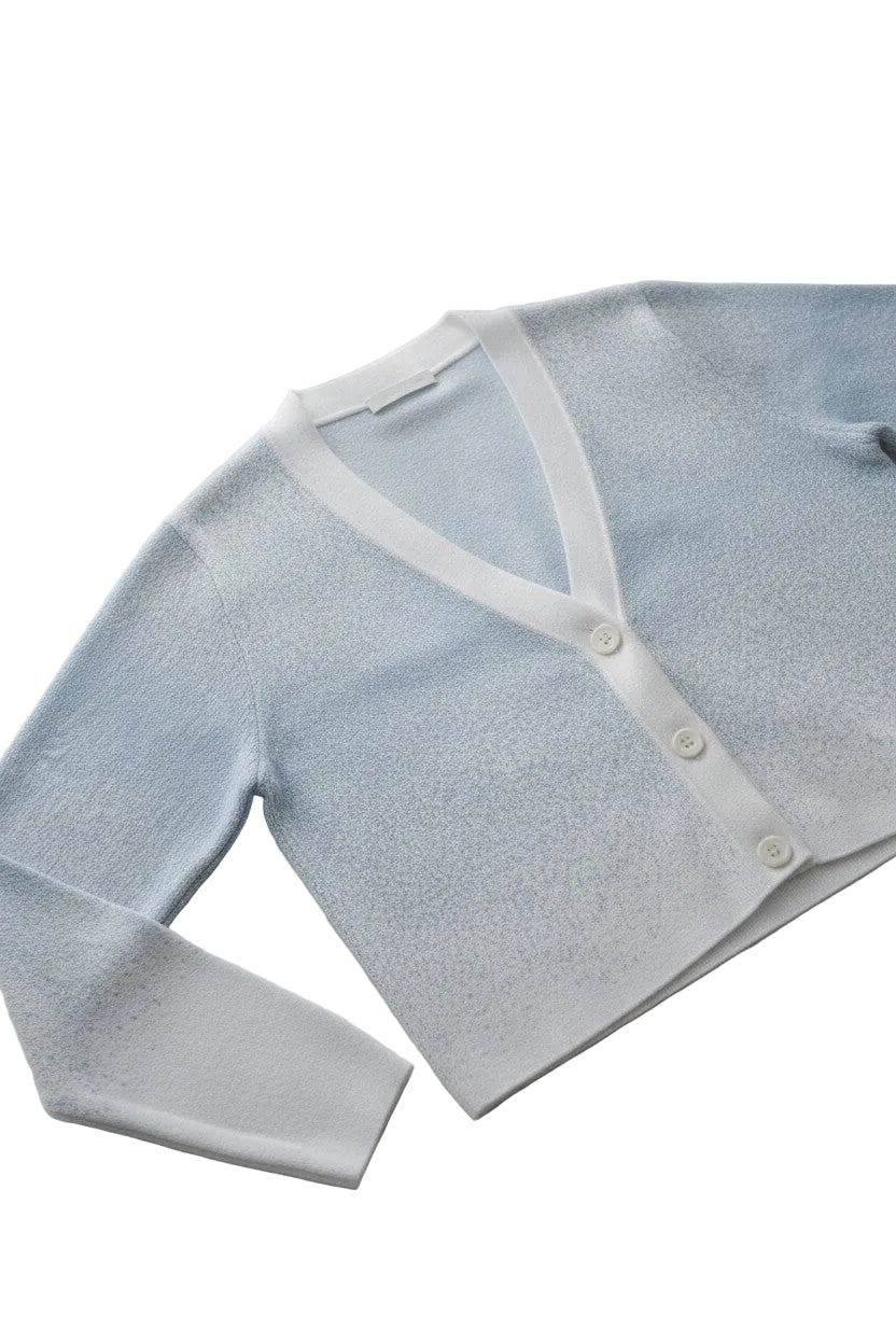 Light blue baby cardigan with white buttons on a white background.