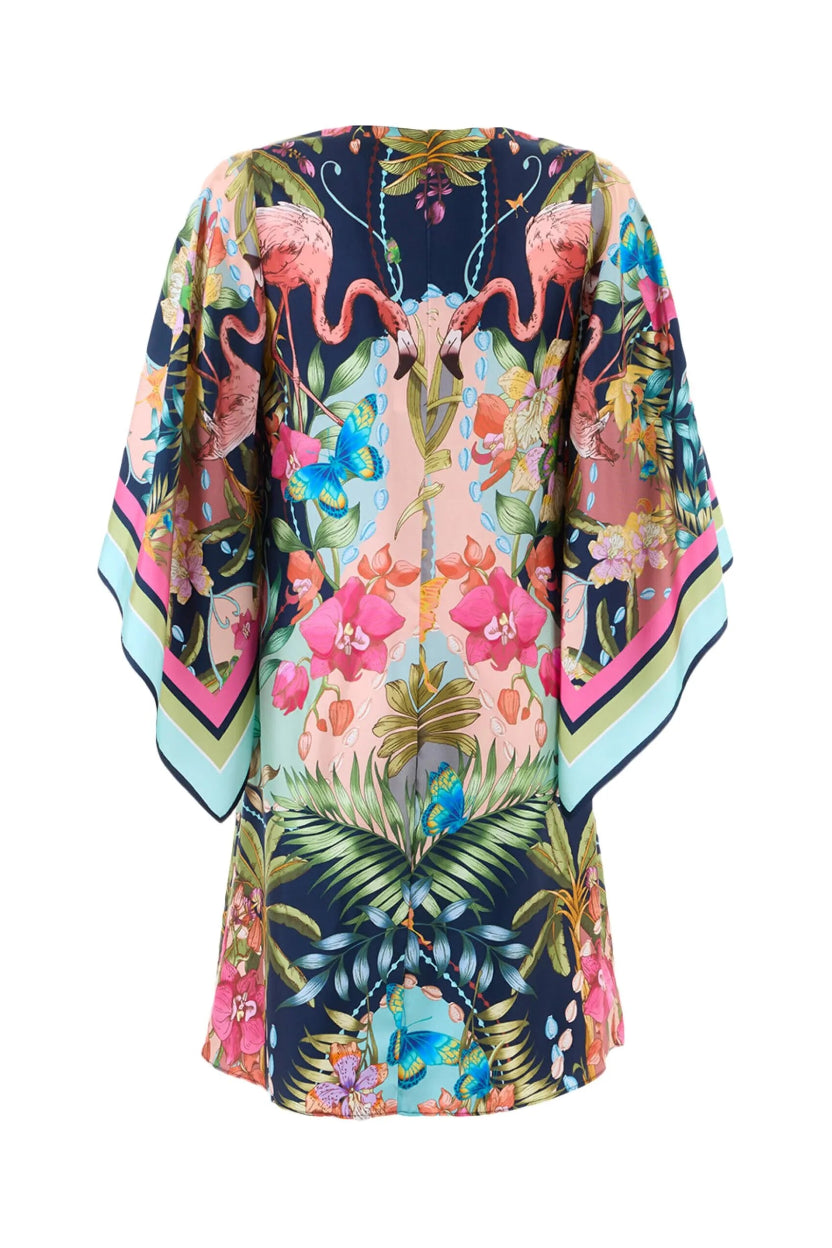 The back of a colorful kimono-style dress with floral and flamingo design on a white background.