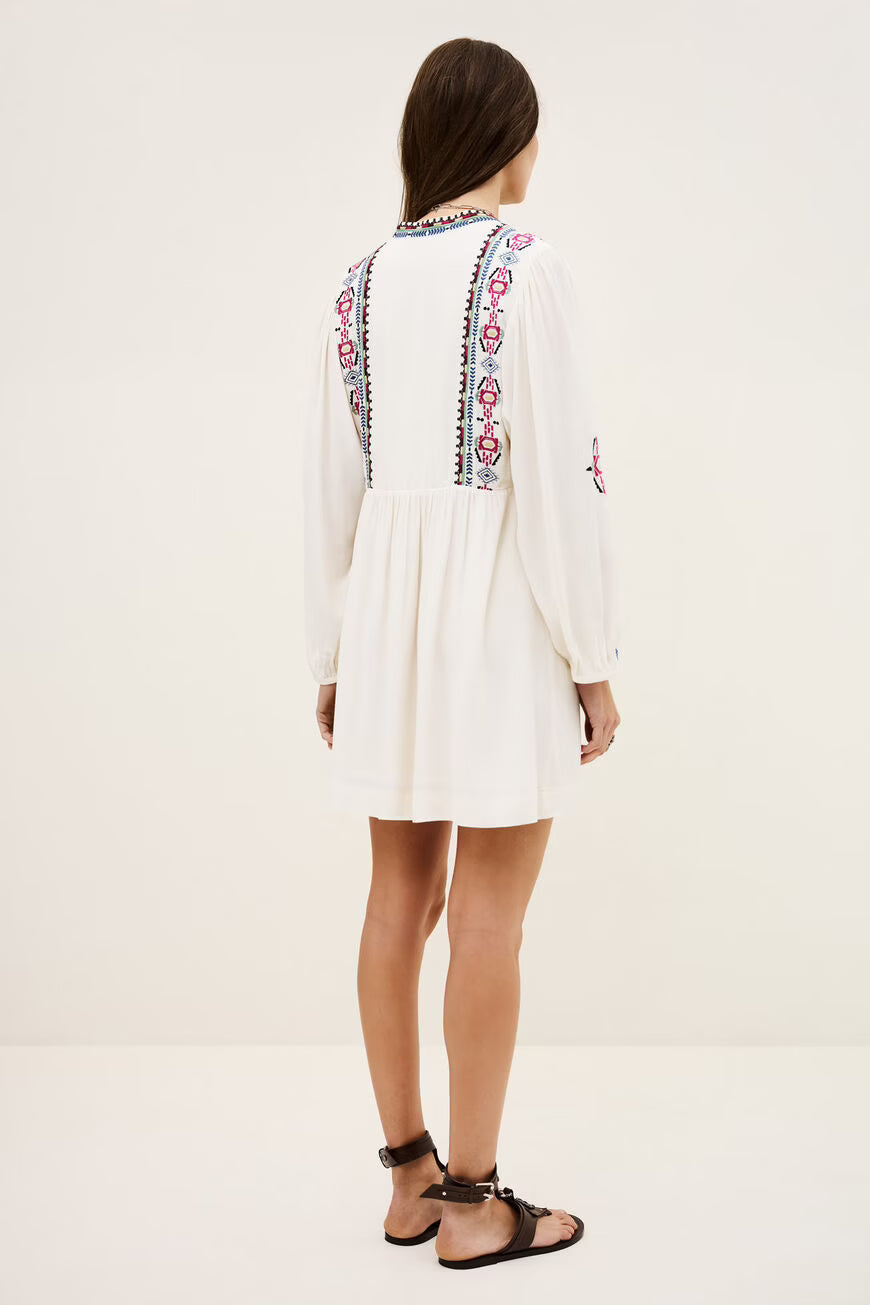 White dress with colorful embroidery on a white background.