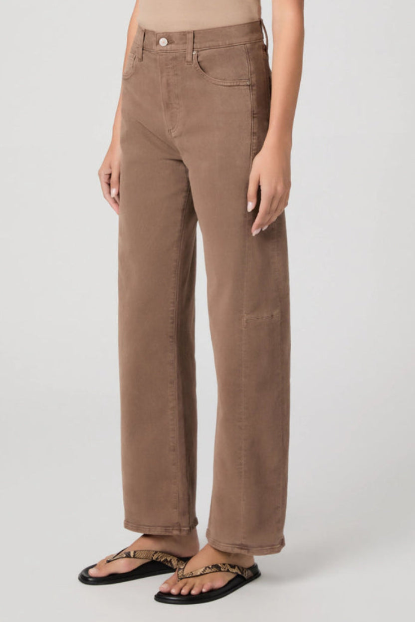 Brown pants worn by a person on a white background.