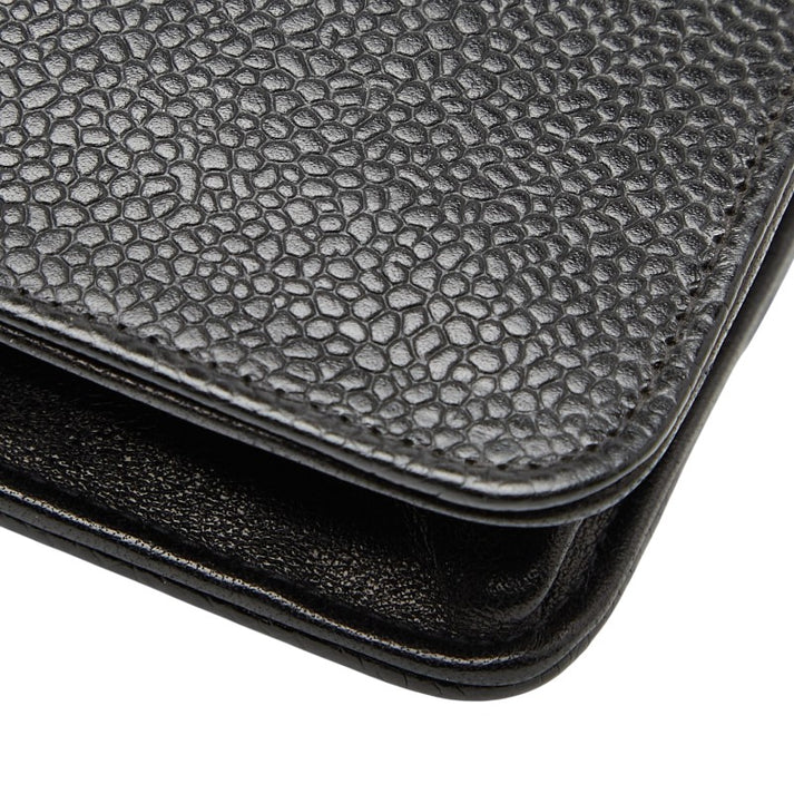 Close-up of a textured black leather bag.