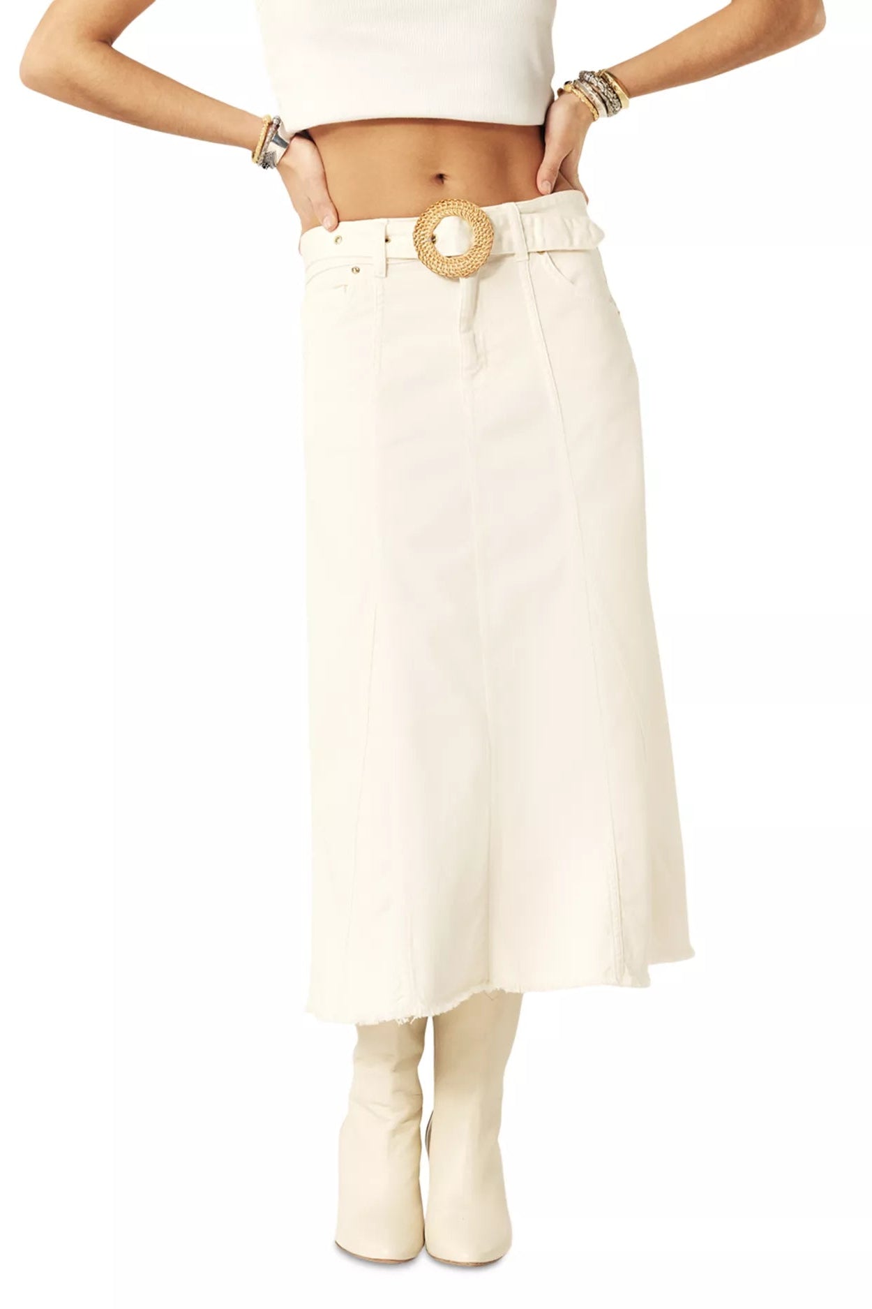 Woman wearing a white skirt with a belt on a white background.