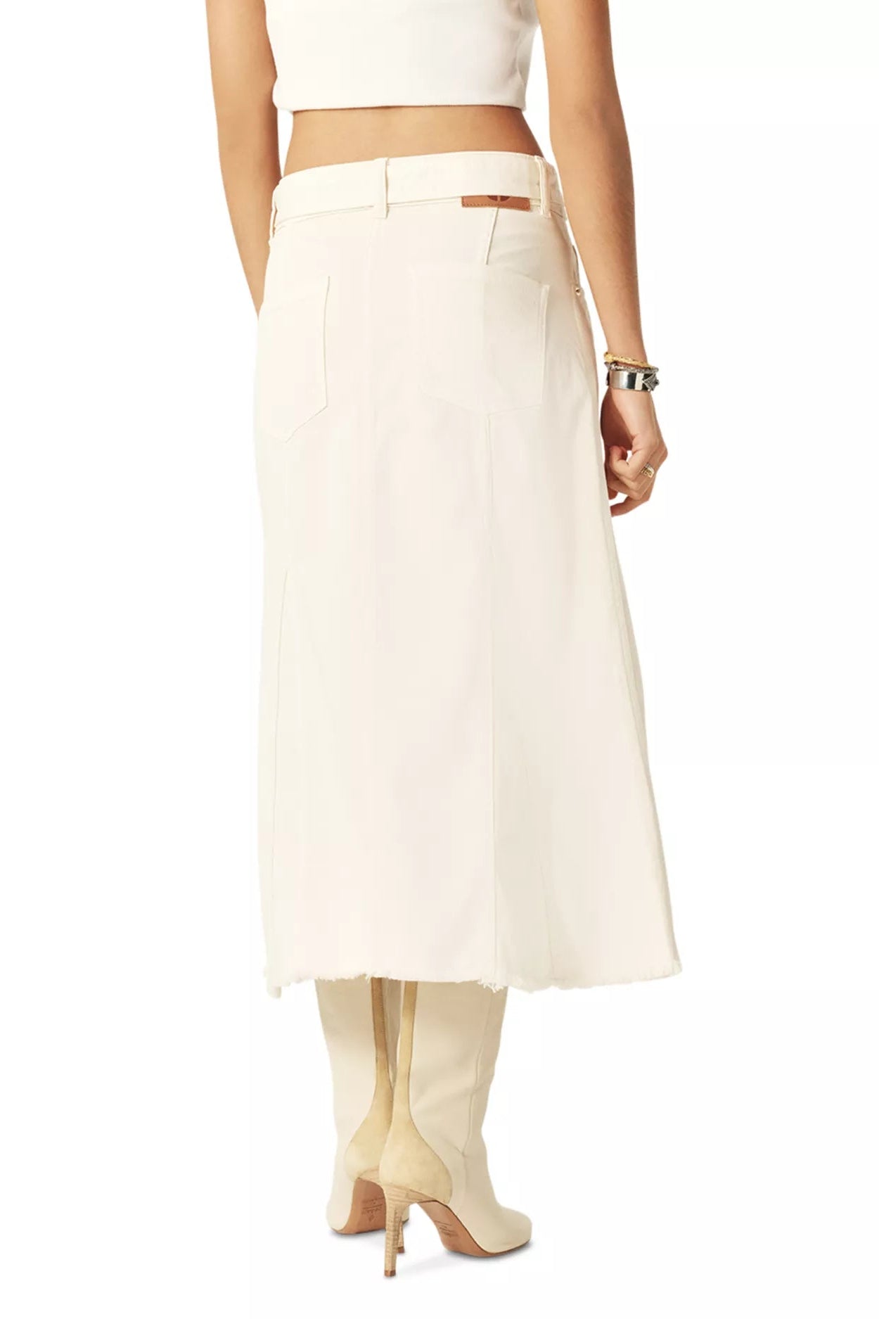 The back of a woman wearing a white skirt and top on a white background.