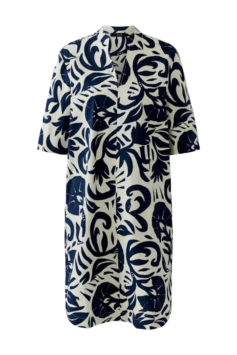 Tunic style dress with navy abstract floral pattern on a white background.