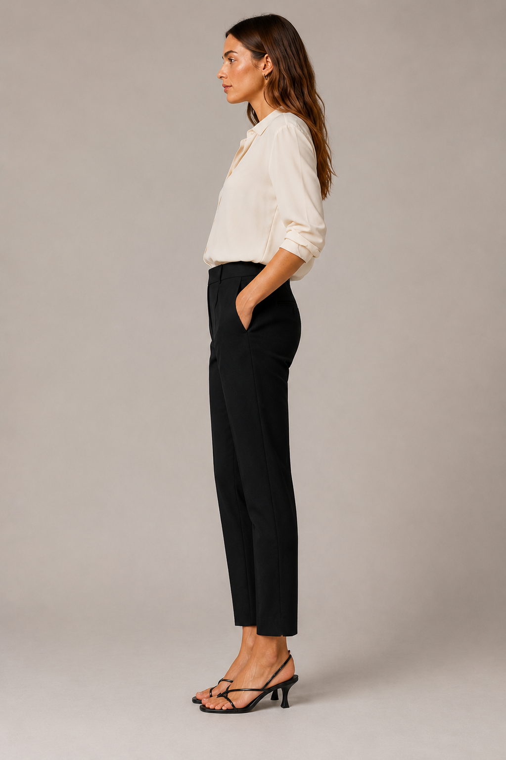 Model wearing the black Peserico Bi-Stretch Canvas Pant from the side with an ivory blouse and black heels.